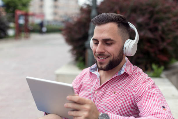 istock Man with headphones and digital tablet 1214982771