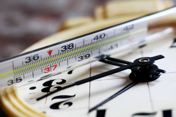 istock Medical thermometer and watch 1214983943