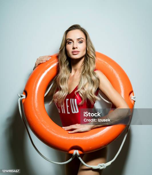 Summer Portrait Of Blonde Woman Holding Life Buoy Stock Photo - Download Image Now - Lifeguard, Sensuality, Women