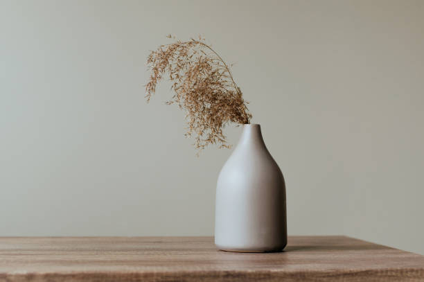 istock Dry reed in modern vase on the wooden table 1214987983