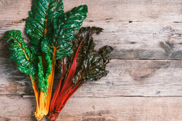 istock Multi-colored swiss chard on wooden background. Top view. Copy space. Zero waste, organic vegetables concept. Vegan and vegetarian diet food. 1214990137
