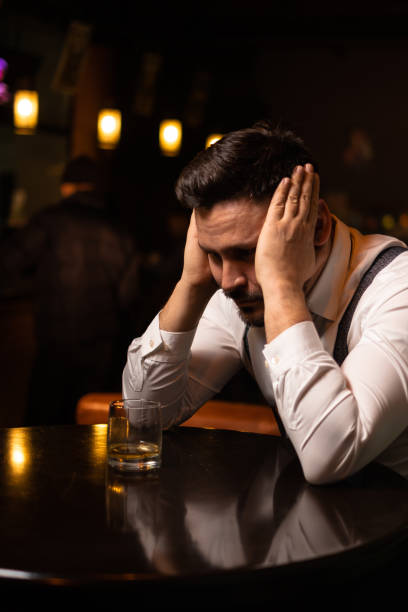istock man seats at the bar and drinking 1214990273