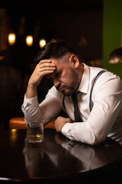 istock man seats at the bar and drinking 1214990375