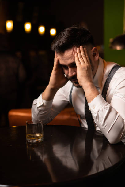 istock man seats at the bar and drinking 1214990427