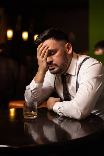 istock man seats at the bar and drinking 1214990509