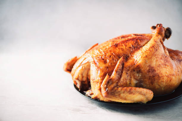 istock Whole roasted chicken in baking dish. Top view. Copy space. Macro shoot. 1214991461