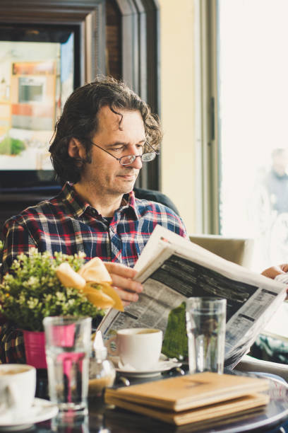istock Adult man reading newspaper 1214992159