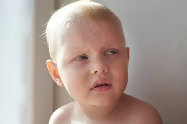 Little blond boy with a funny expression, can be used as an Internet meme.