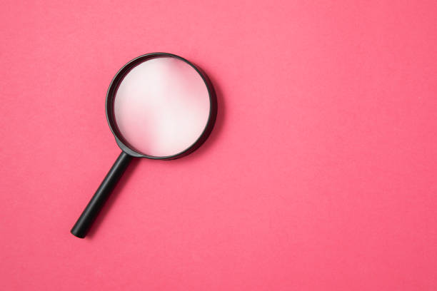 istock Magnifying Glass on Pink Background 1214992479