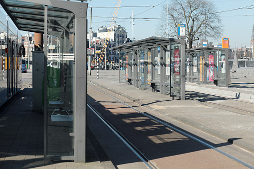 Amsterdam, Center / Netherlands - March 25 2020: Empty tram stations or bus shelters near Amsterdam Central. No passengers because most people staying at home.