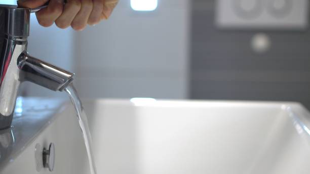 istock Hands opening water at the sink 1214994175