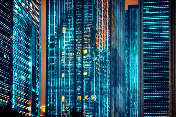istock Business district skyscrapers, Office windows by night 1214998955