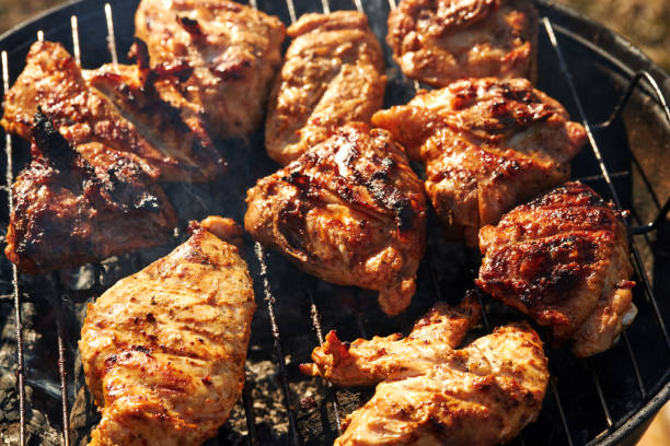 istock Chiken barbeque on a grill roasting open fire spring summer time 1214999176