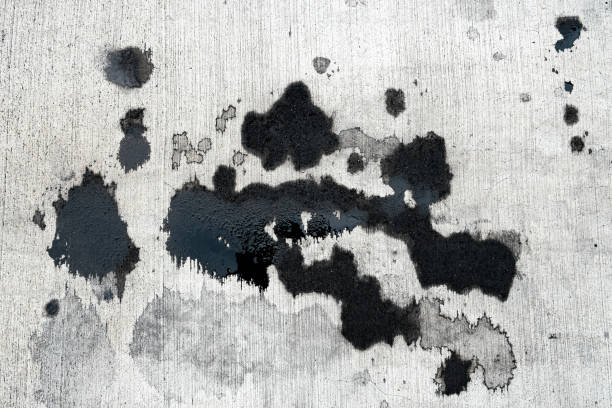 Stains of car oil drips and spots on concrete stock photo