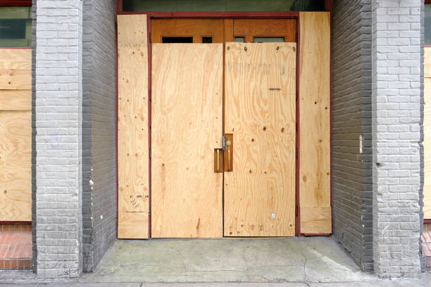 Closed or failed business location with boarded up front doors. Concept of economic crisis with many closed restaurants due to coronavirus. stock photo