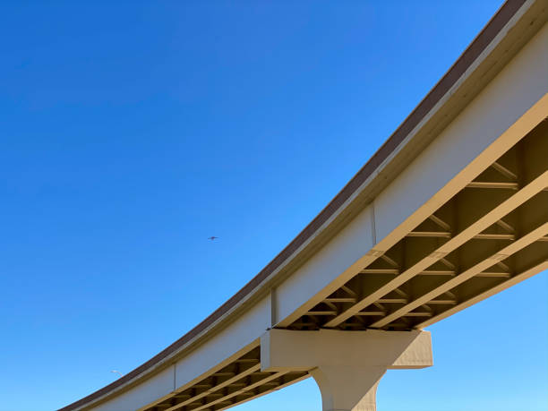 istock Section of newly constructed elevated highway against a bright blue sky 1215000459
