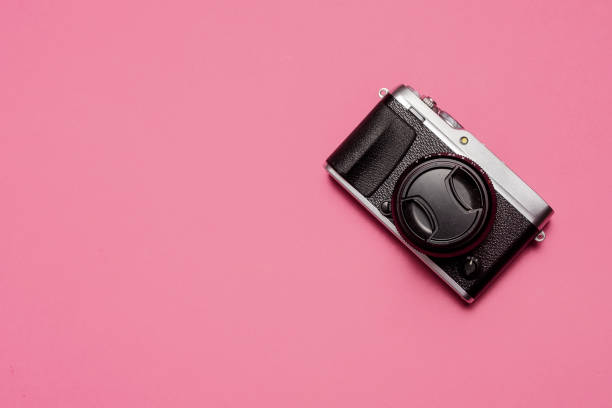 istock Vintage retro mirrorless camera on pink 1215000468