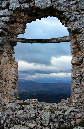 The storm in the valley, seen through the gash in the ruined wall, Rocca Calascio, L'Aquila, Abruzzo, Italy