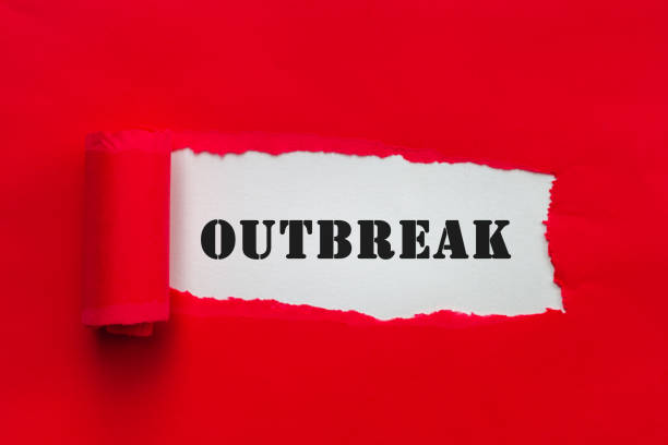 istock Torn red paper revealing text outbreak. Warning concept for coronavirus outbreak 1215000667
