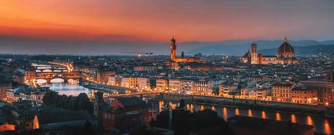 Aerial and panoramic view of Arno River, Duomo Cathedral and Ponte Vecchio and cityscape during beautiful sunset, Florence, Italy. High Resolution. XXXL