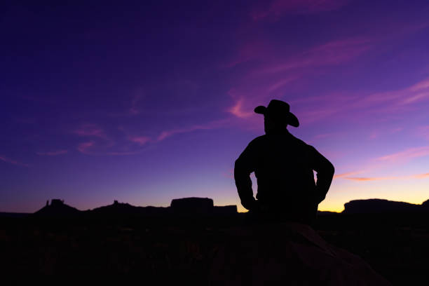 istock Cowboy Silhouette with Red Rock Canyon 1215001814