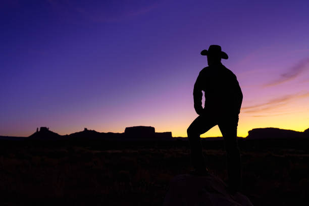istock Cowboy Silhouette with Red Rock Canyon 1215002035