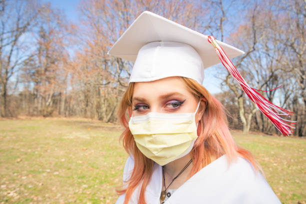 istock Social Distancing Graduate in Face Mask Outdoors Coronavirus Era 1215002108