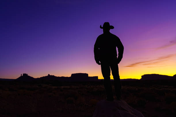 istock Cowboy Silhouette with Red Rock Canyon 1215002130