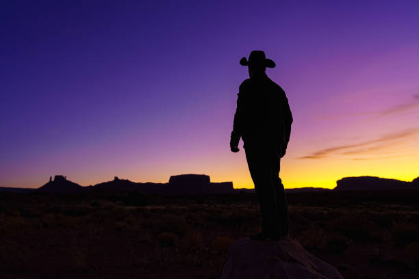 istock Cowboy Silhouette with Red Rock Canyon 1215002260