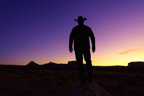 istock Cowboy Silhouette with Red Rock Canyon 1215002448