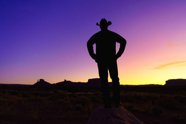 istock Cowboy Silhouette with Red Rock Canyon 1215002574