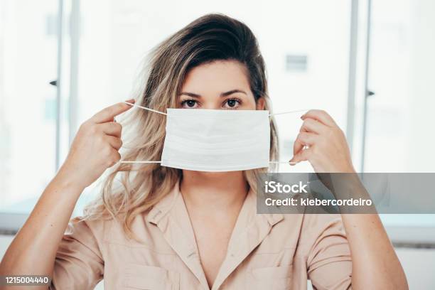 Portrait Of Woman Wearing Surgical Mask At Home Covid19 Coronavirus And Quarantine Concept Stock Photo - Download Image Now