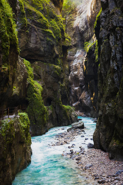 istock A stormy, mountain river flows through a gorge into which sunlight penetrates. 1215005033