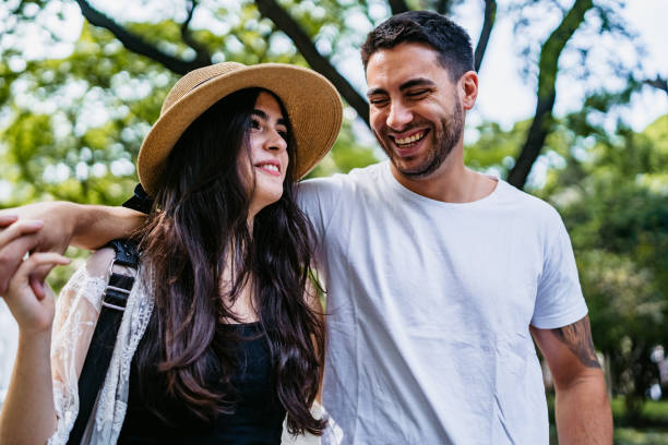 istock Young couple walking in park 1215005878