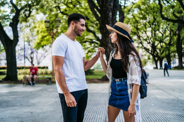 istock Young couple walking in park 1215005944