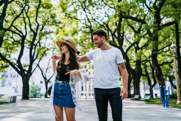 istock Young couple walking in park 1215006011