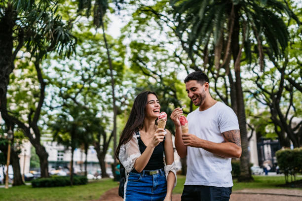 istock Happy couple sharing ice cream 1215006384