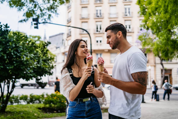 istock Happy couple sharing ice cream 1215006411
