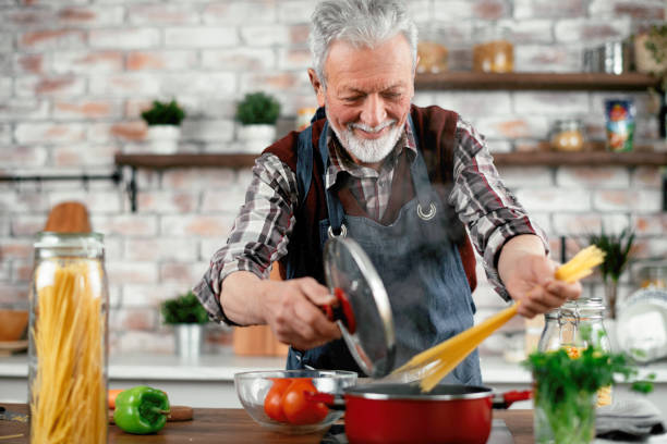 istock Grandfather cooking in kitchen. 1215007242
