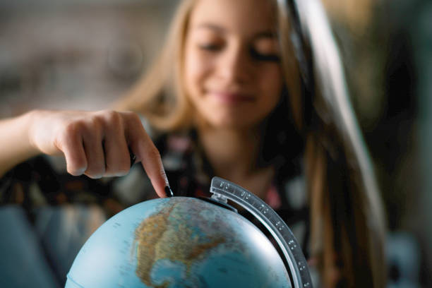 Beautiful young girl discovering world Little girl with globe. Beautiful young girl discovering world. student travel stock pictures, royalty-free photos & images