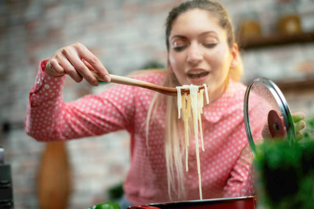 istock Beautiful woman in kitchen. 1215007445
