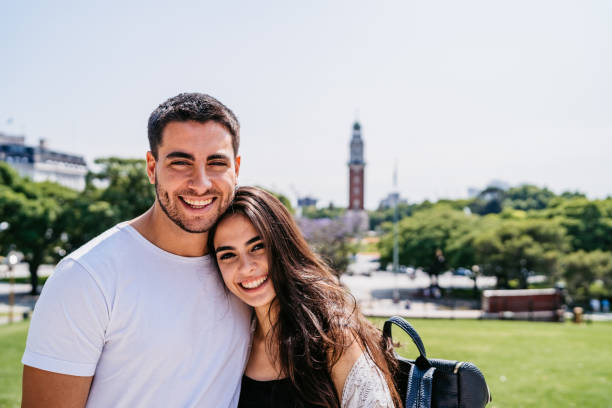 istock Young beautiful smiling couple in park 1215007656
