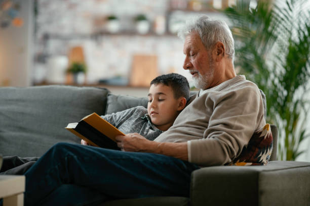 istock Grandpa and grandson reading together 1215009342