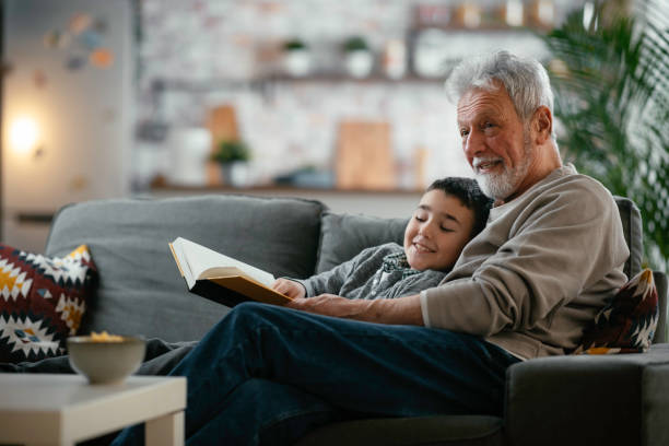 istock Grandpa and grandson reading together 1215009355