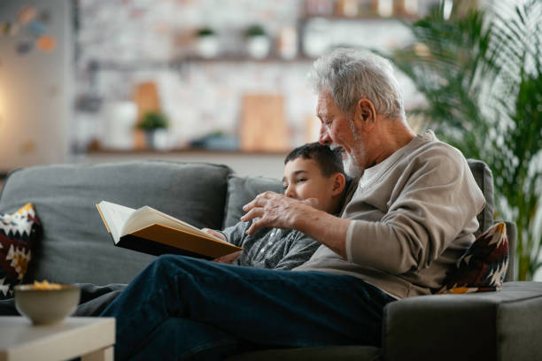 istock Grandpa and grandson reading together 1215009363