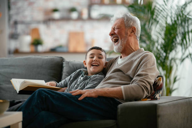 istock Grandpa and grandson reading together 1215009364