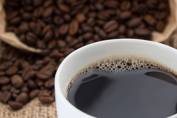 istock cup of coffee with grains background 1215010296