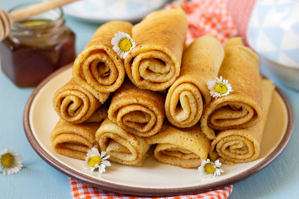 istock Sweet thin pancakes crepes served with honey 1215010371