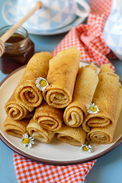 istock Sweet thin pancakes crepes served with honey 1215010372