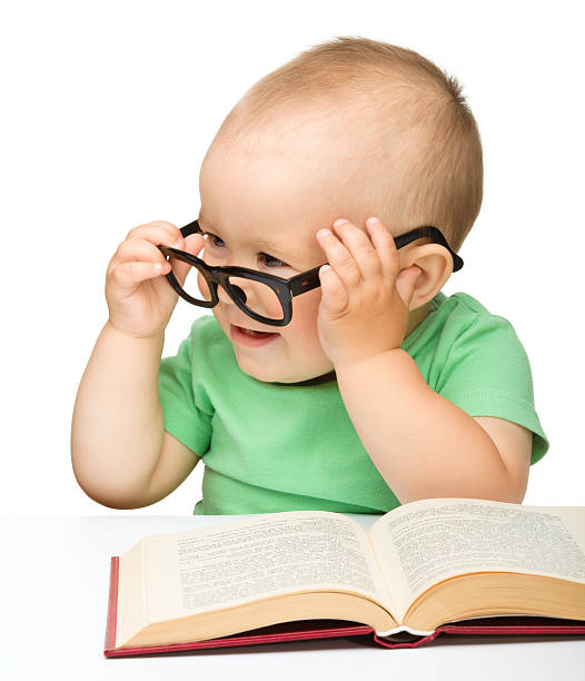 istock Little child play with book and glasses 121501065